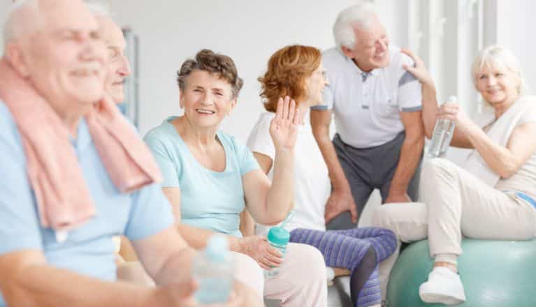 Group of elderly sitting on couch after exercise